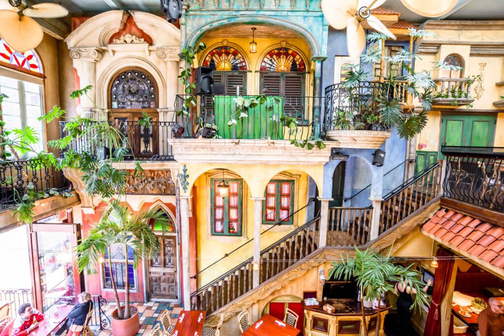 A colorful interior of a restaurant, made to look like a city street in Havana, Cuba.