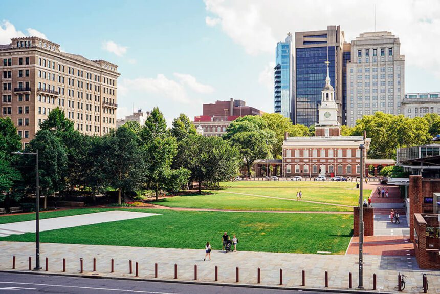 Green lawn with a historical brick building in the background.