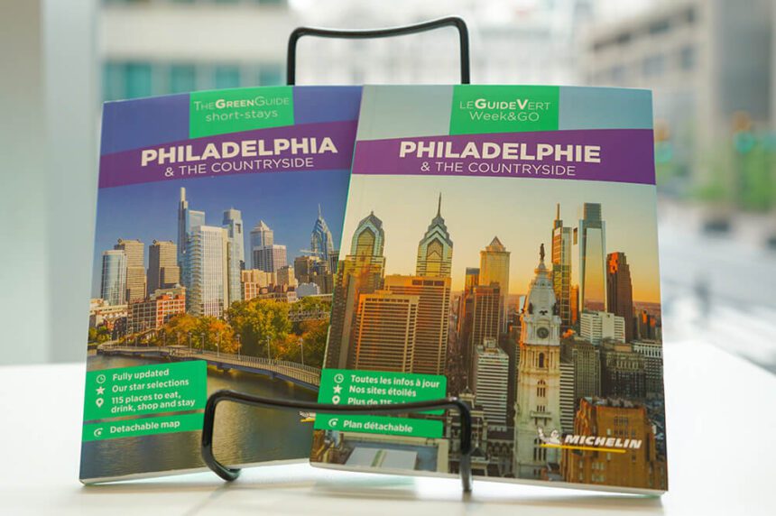 A French and English version of the Michelin Green Guide sit on a stand in front of a window.