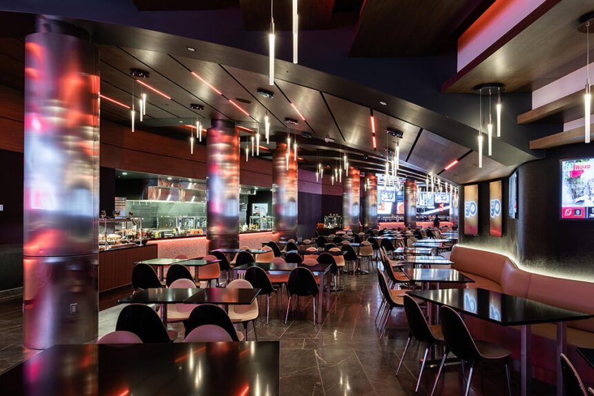 A modern room full of seating and red and purple lighting.