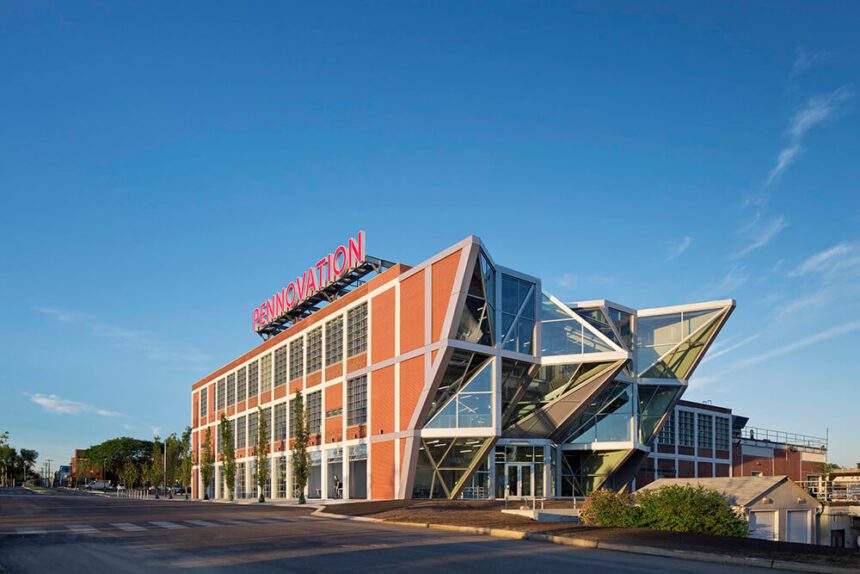 A red building against a blue sky with geometric architectural features.