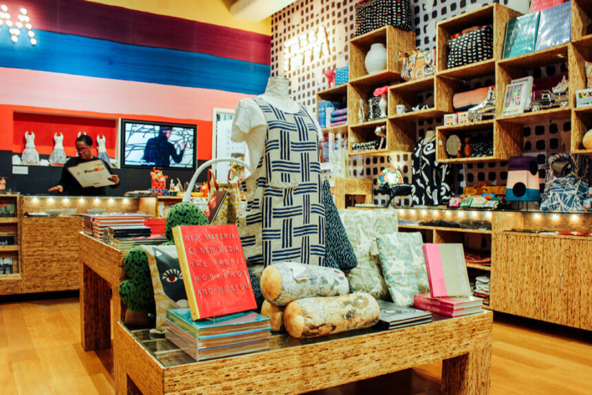 A colorful gift shop with books and clothing for purchase.