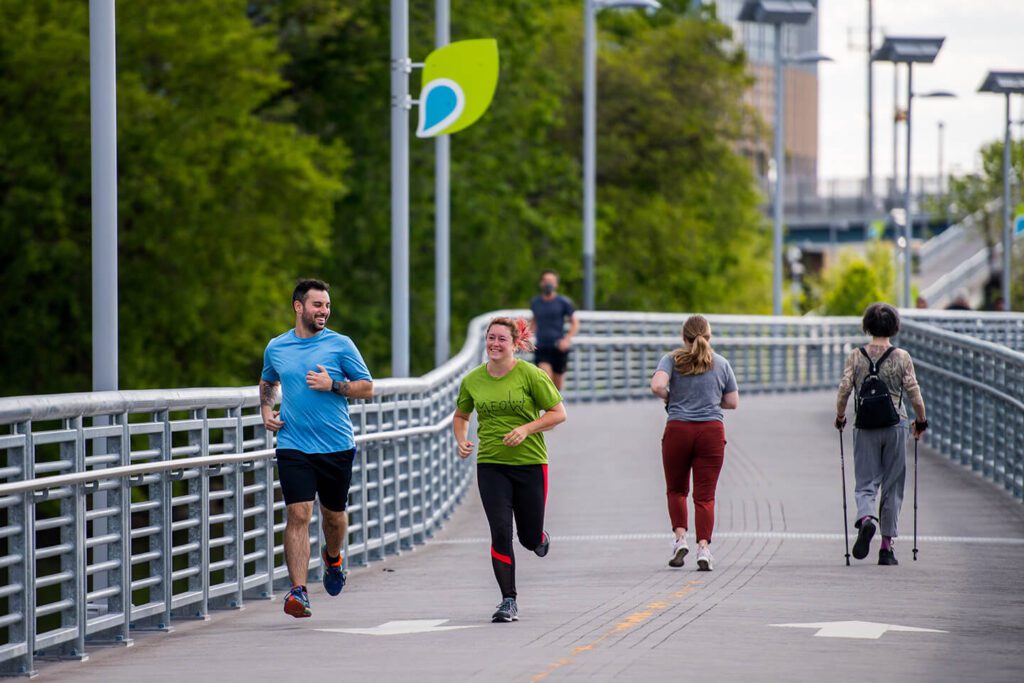 People run along the Schuykill river