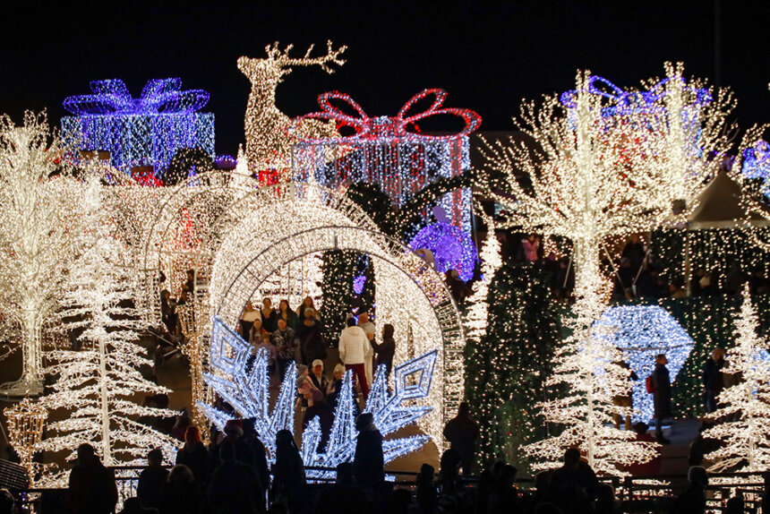 A lon of white and red and blue lights are shown. Lights cover presents, deer, tunnels, and trees.