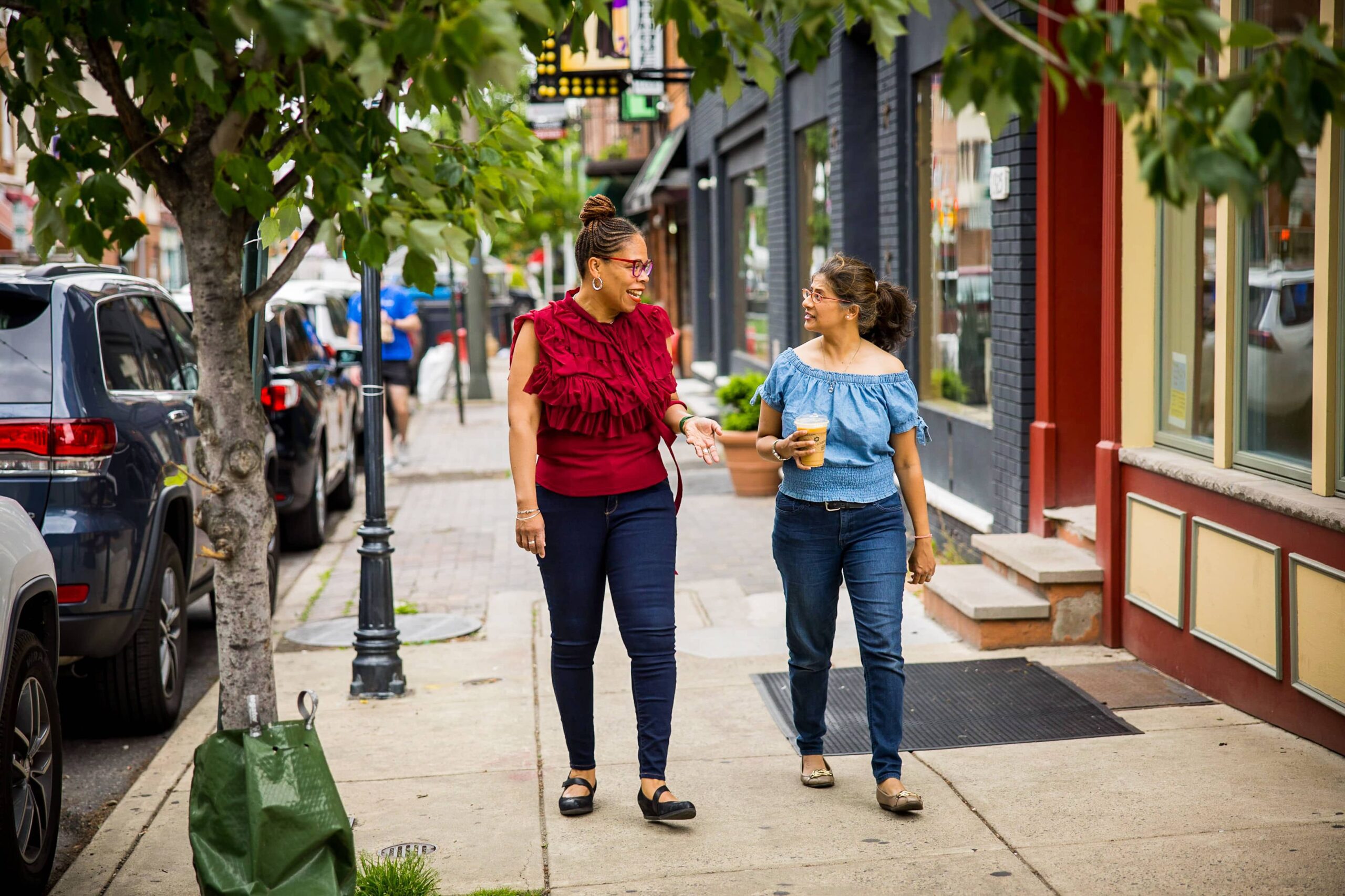 Two people walking in a Philadelphia neighborhood.