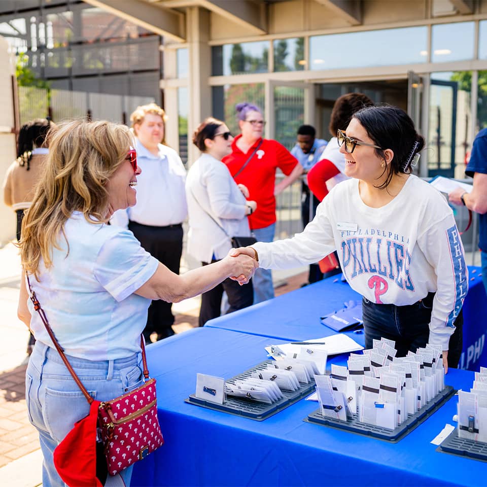 Two people shaking hands at an event in Philadelphia.