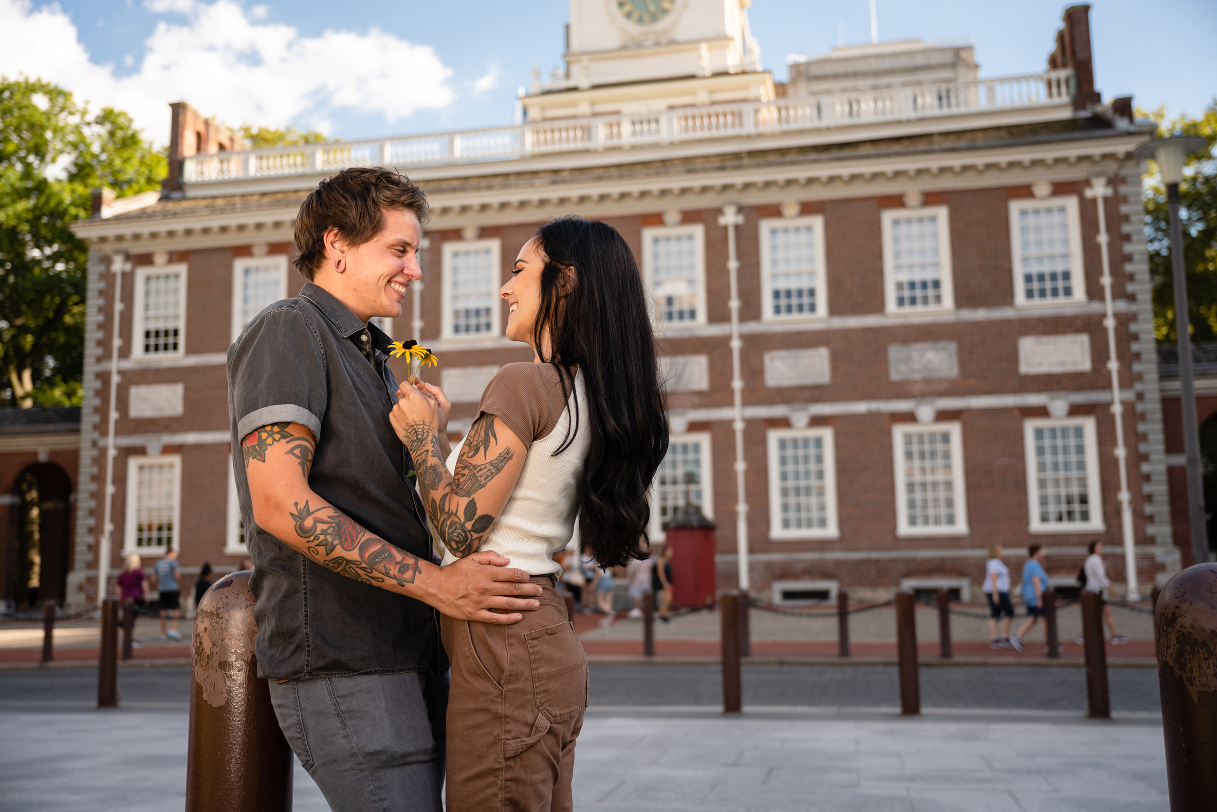 A LGBTQ couple embrace outside of Independence Hall