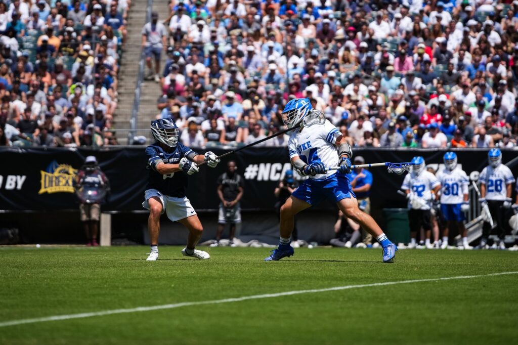 A Penn State lacrosse player matches up against a Duke Lacrosse player at the NCAA Men's lacrosse Championships 2023 at Lincoln Financial Field.
