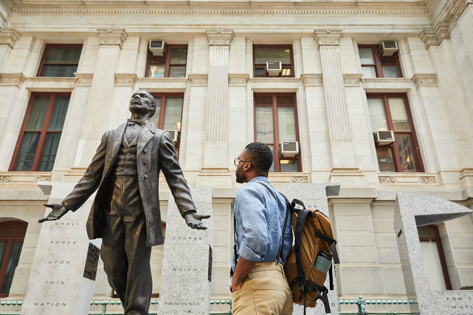 A person looking at a historical statue in Philadelphia.