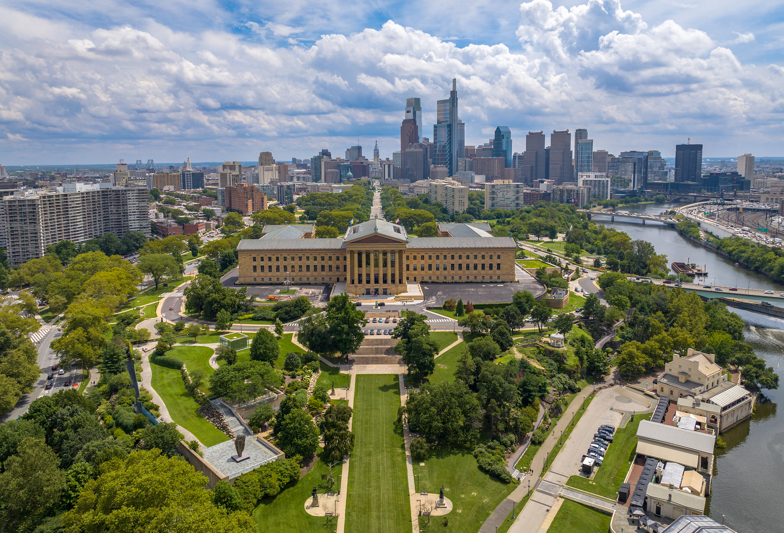 Elevated view of the Philadelphia skyline with the Philadelphia Museum of Art in the foreground and the tall city skyline in the background.
