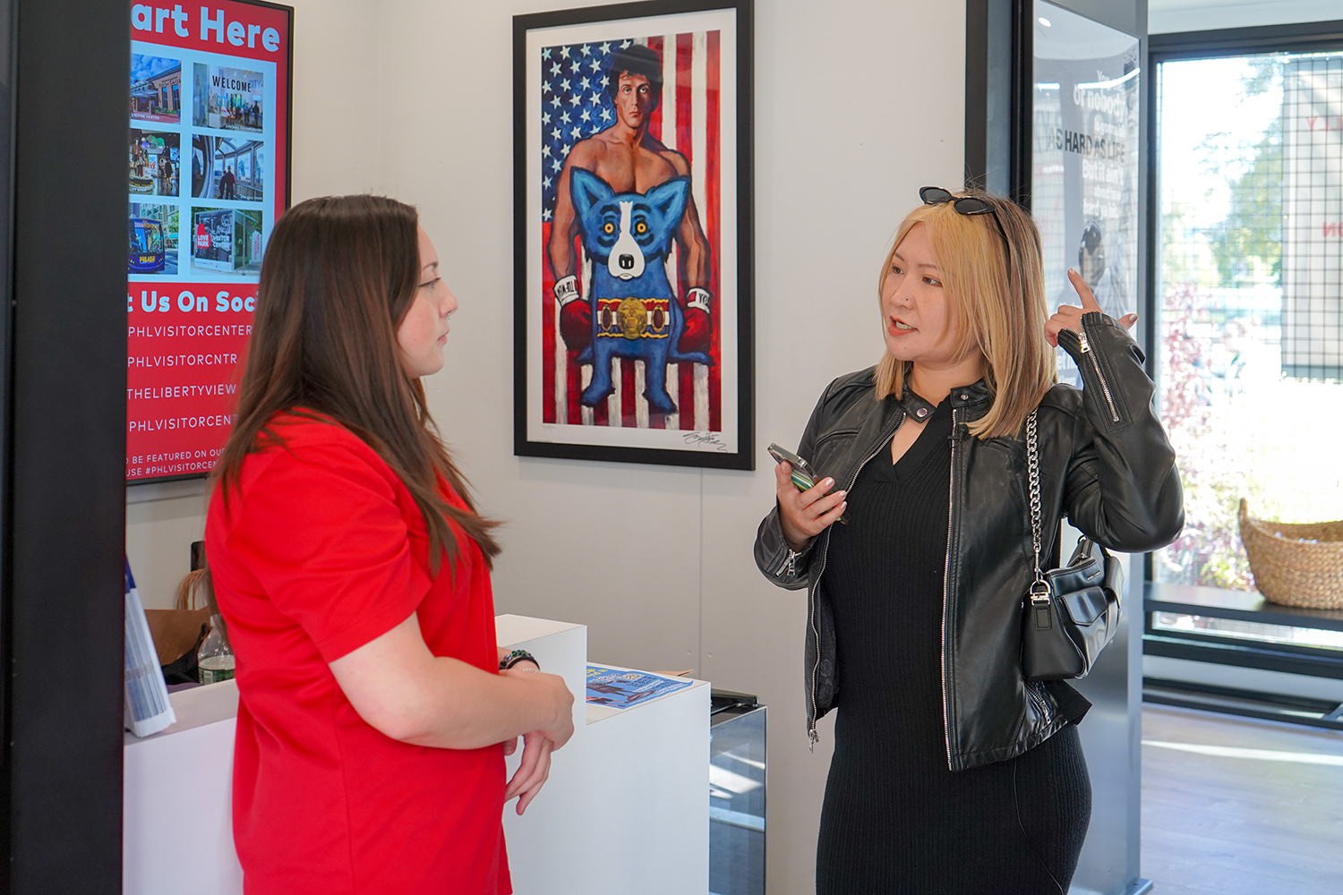 Two people speak to each other inside the visitors center.