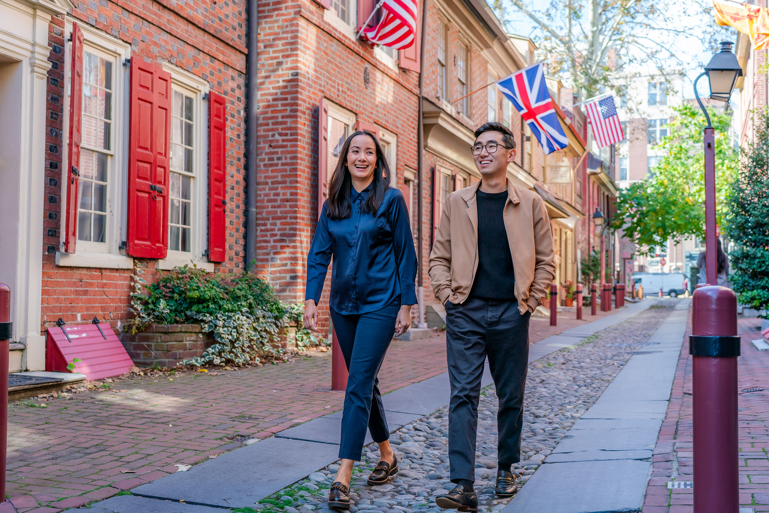Two people walk down Elfreth's Alley.