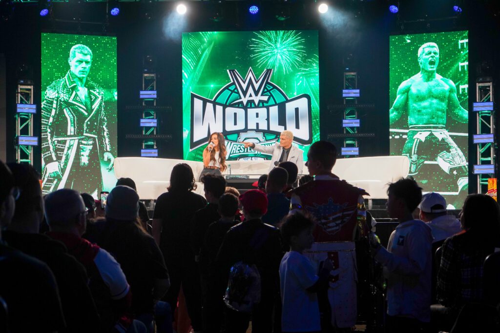 Cody Rhodes speaking to a moderator on stage at WWE World at the Pennsylvania Convention Center.