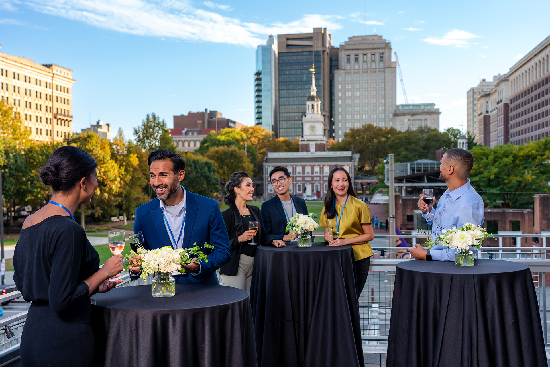 A group gathers on a rooftop in front of historic Independence Hall.