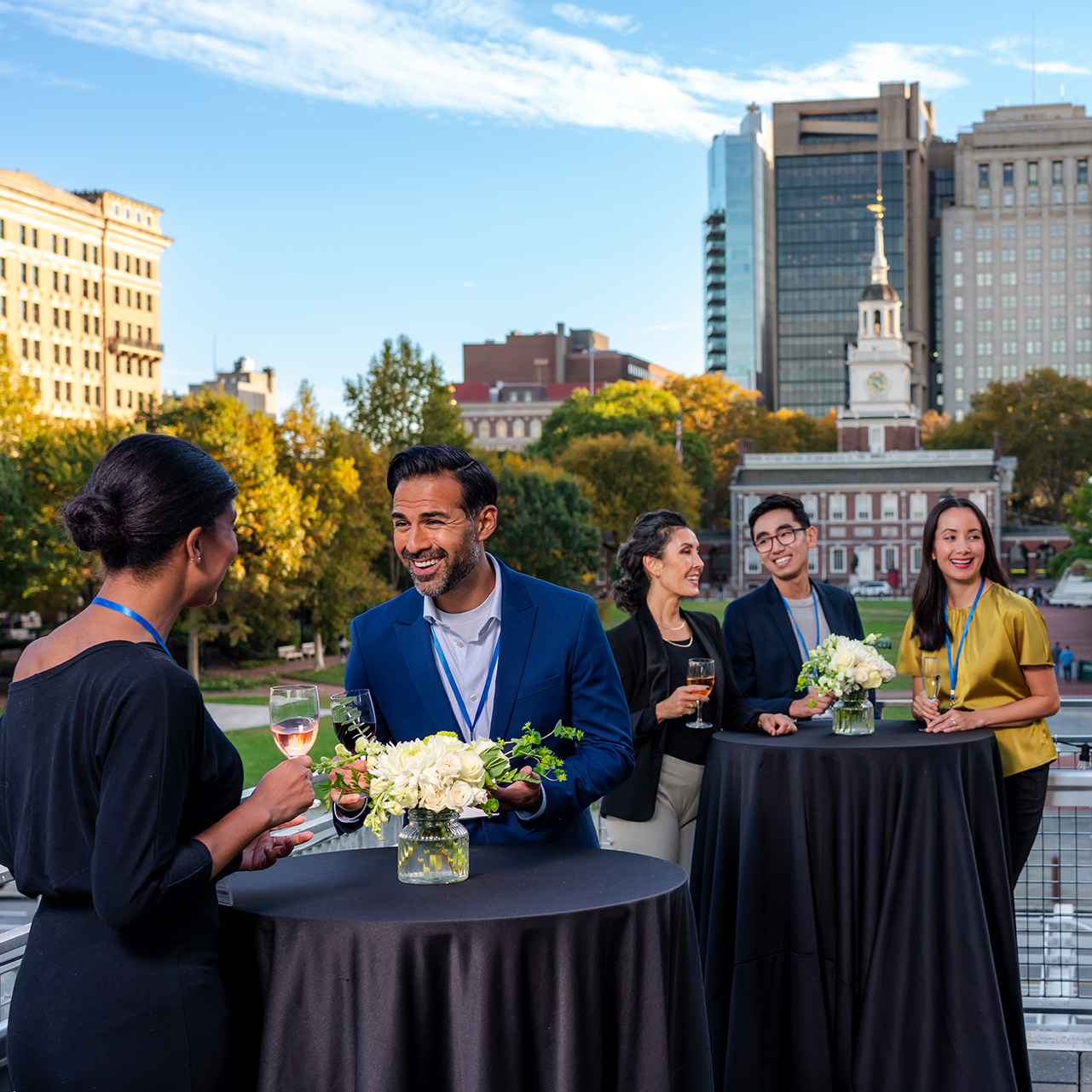 A group gathers on a rooftop in front of historic Independence Hall.