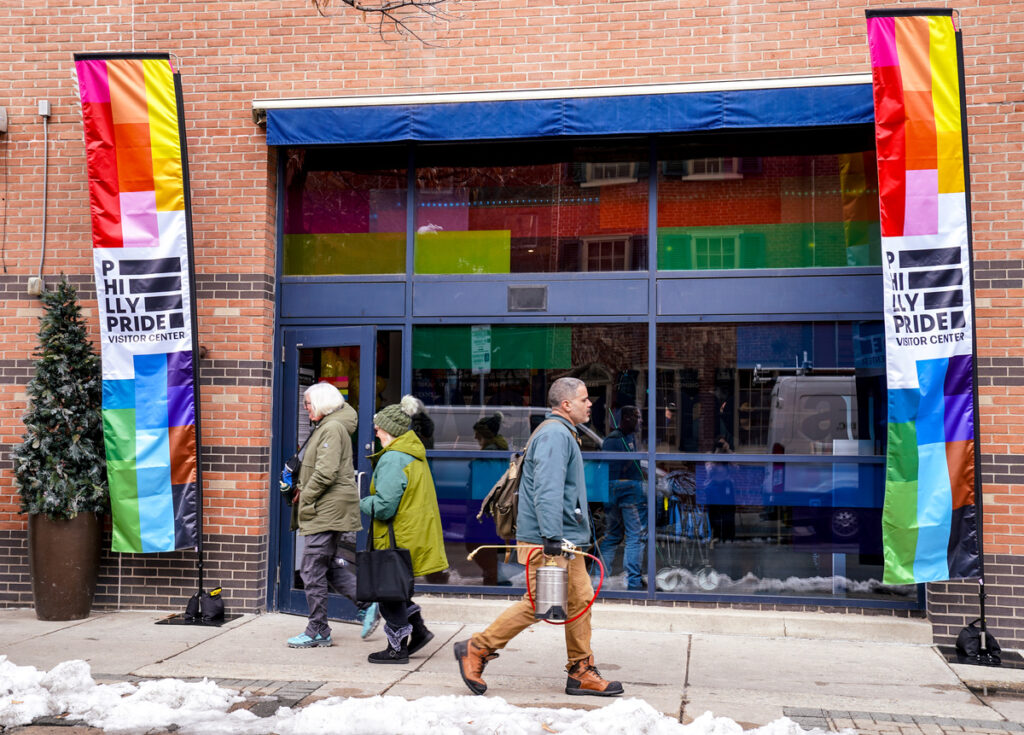 The outside of a Visitors Center with Pride Flags.