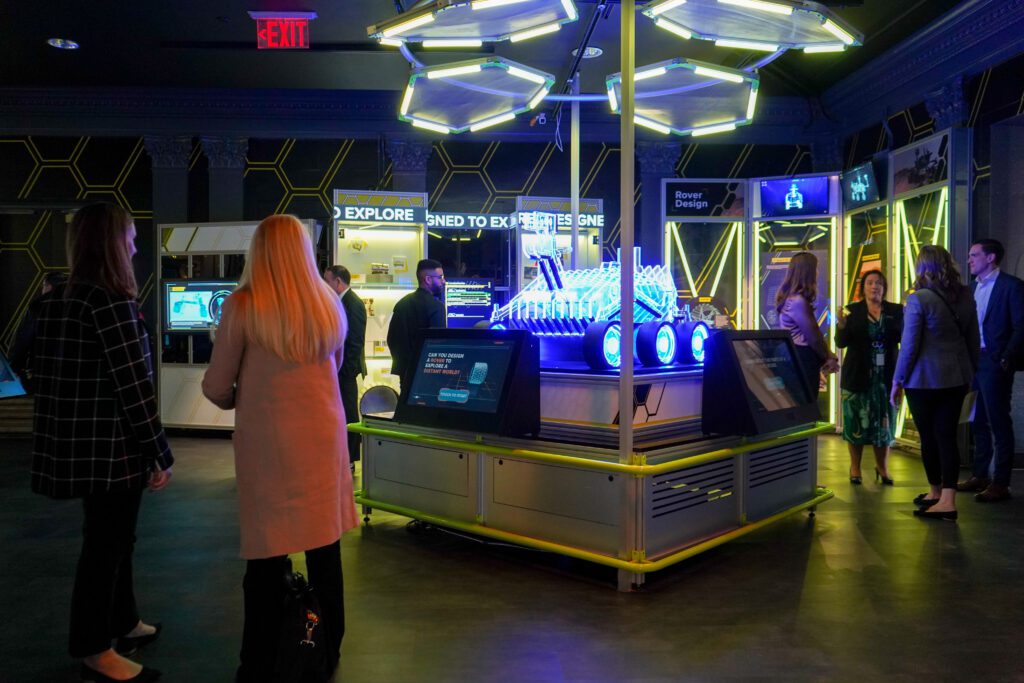 A group of visitors around a space rover exhibit in The Franklin Institute's Wondrous Space.