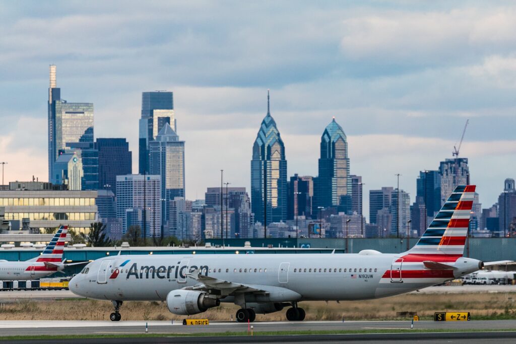 An American Airlines airplane in front of the Philadelphia skyline.