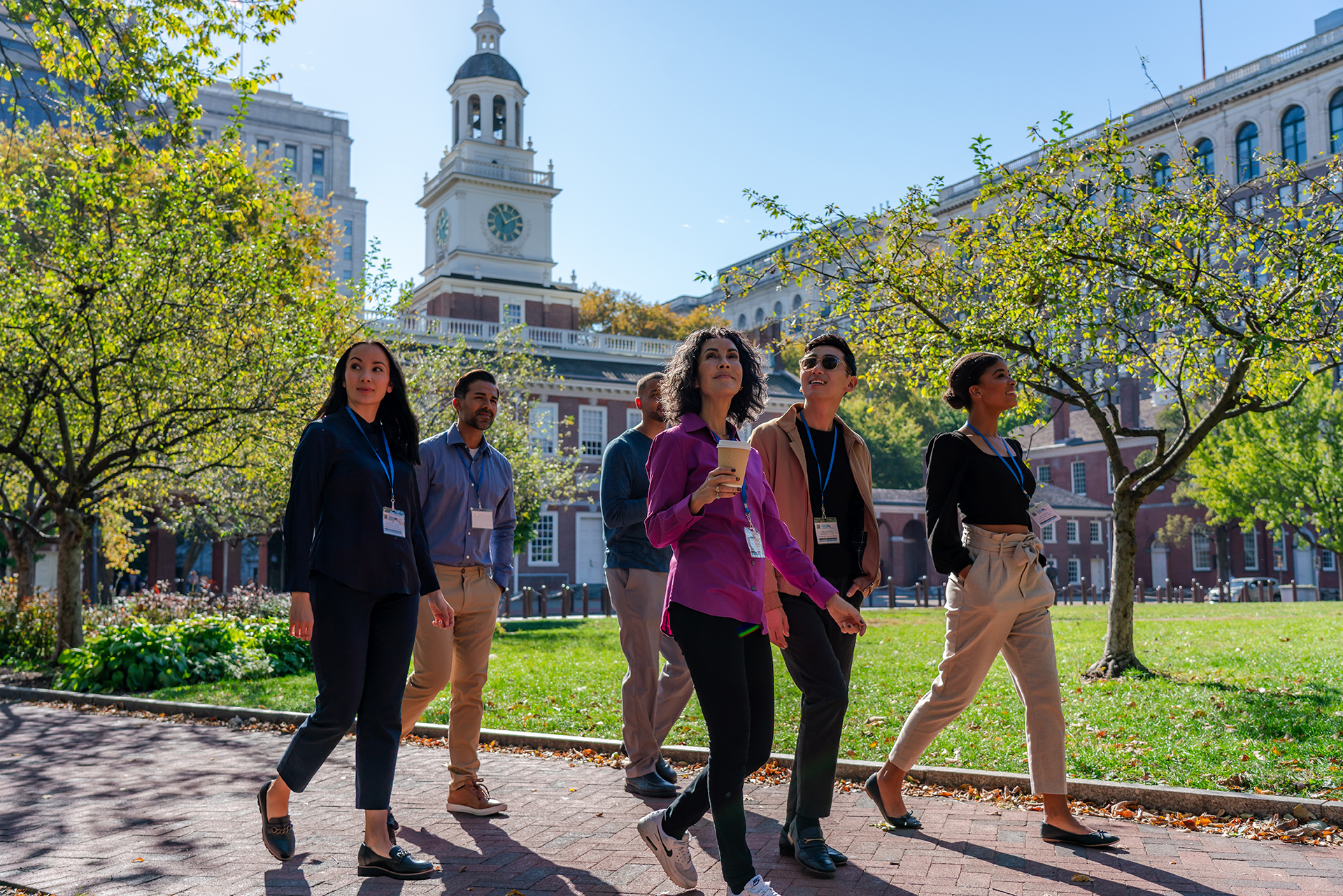 Badge holders walk past Independence Hall.