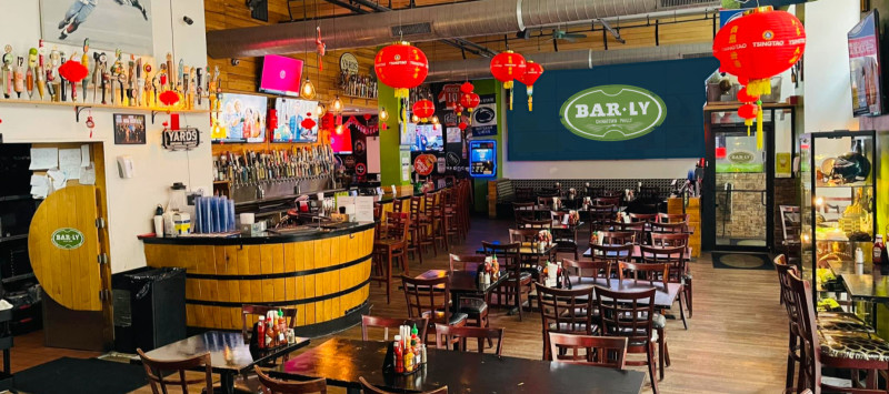 Inside view of Bar-Ly with big screen TVs and lots of seating.
