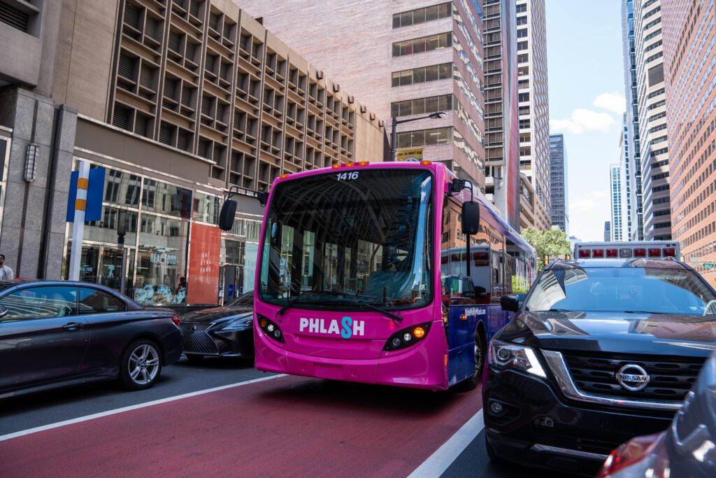 A PHLASH bus driving down the street in Philadelphia.