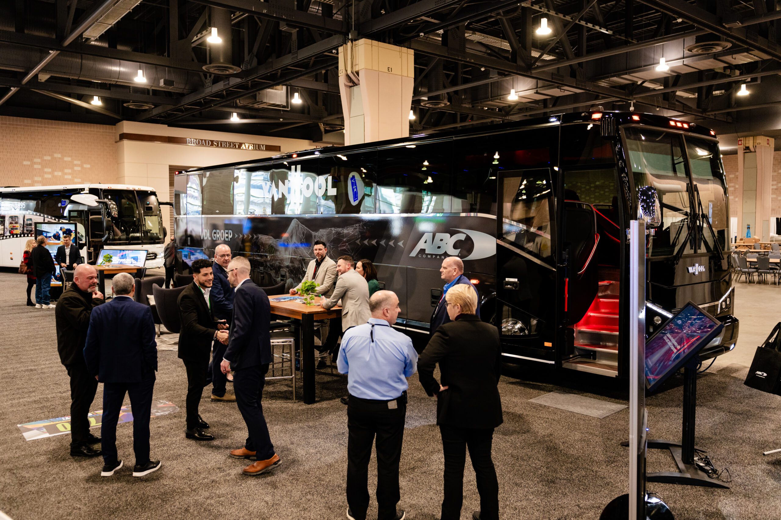 Attendees stand in front of a bus on the showroom floor at the Pennsylvania Convention Center at ABA Marketplace 2025
