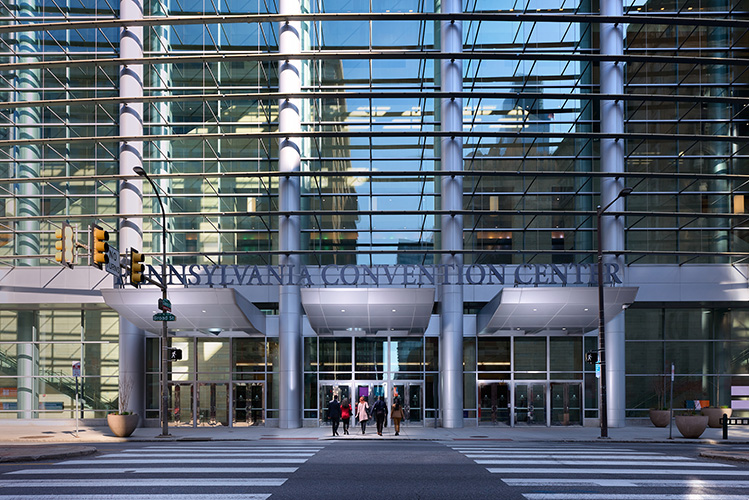 A group walks toward the entrance of the Pennsylvania Convention Center