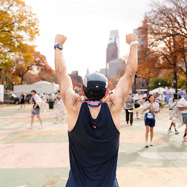 A runner races his fists at the end of a race as a sign of accomplishment