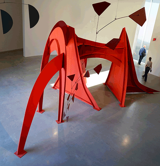 A red Calder sculpture inside Calder Gardens
