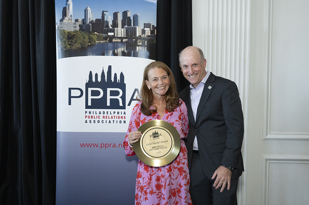 Amy & Larry Needle hold up their award at the PPRA event.
