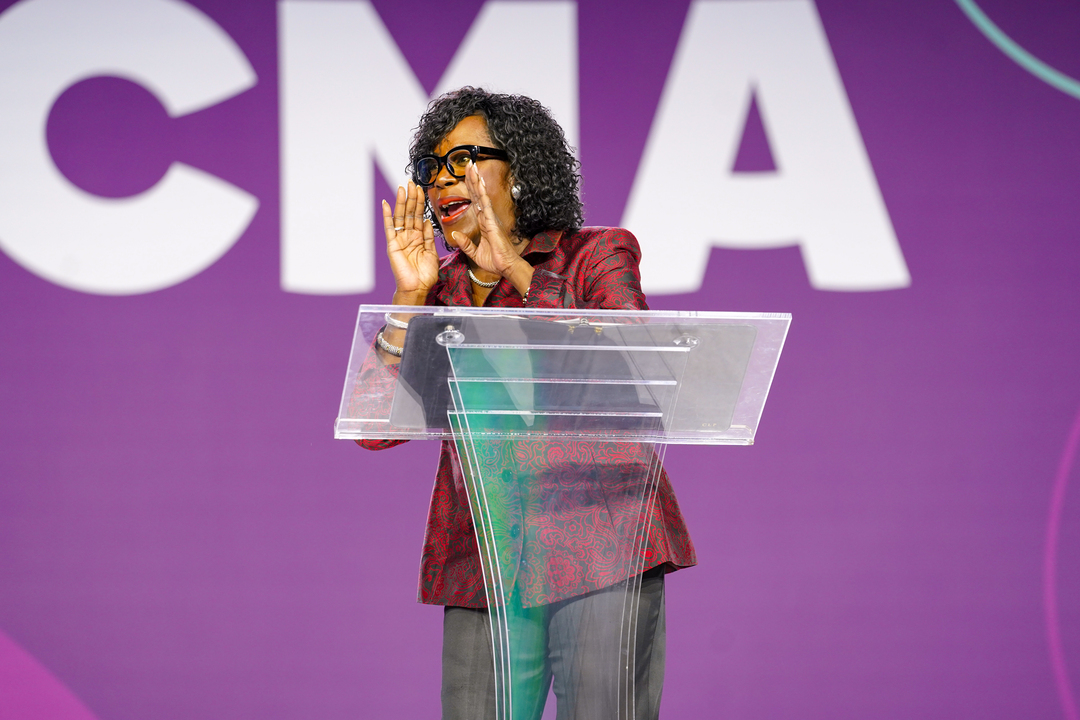 Philadelphia Mayor Parker speaks on a stage behind a podium.