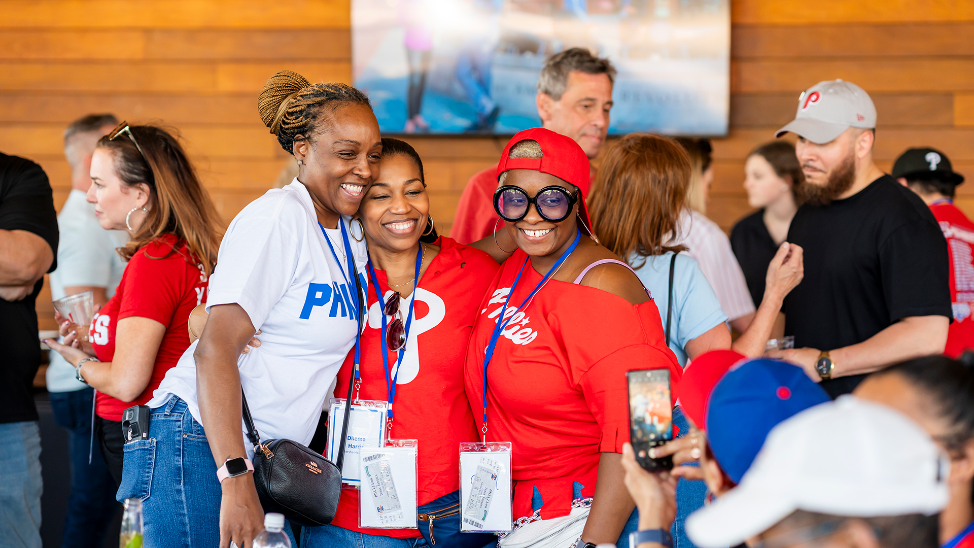 Three people pose for a photo at the PHLCVB Phillies Partner Tailgate.