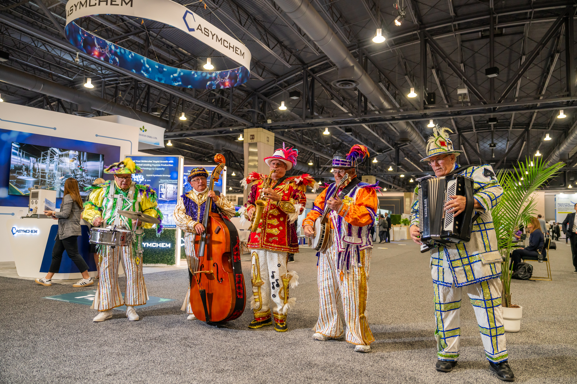 Mummers playing music on the convention center floor.
