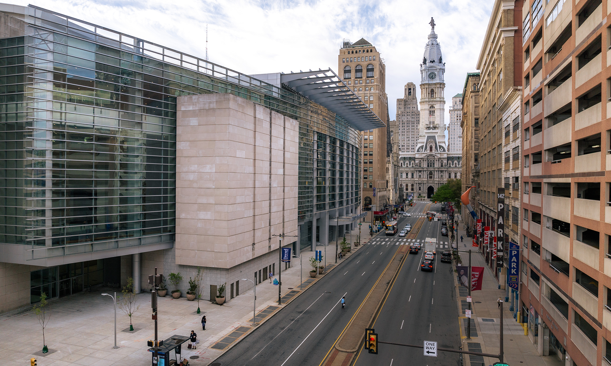 Exterior of the PA convention center with Philadelphia's city hall in the background.