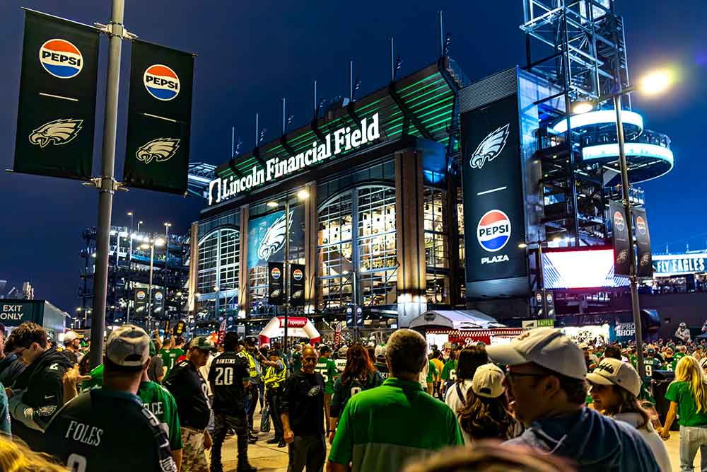 A large crowd of fans walk toward Lincoln Financial Field