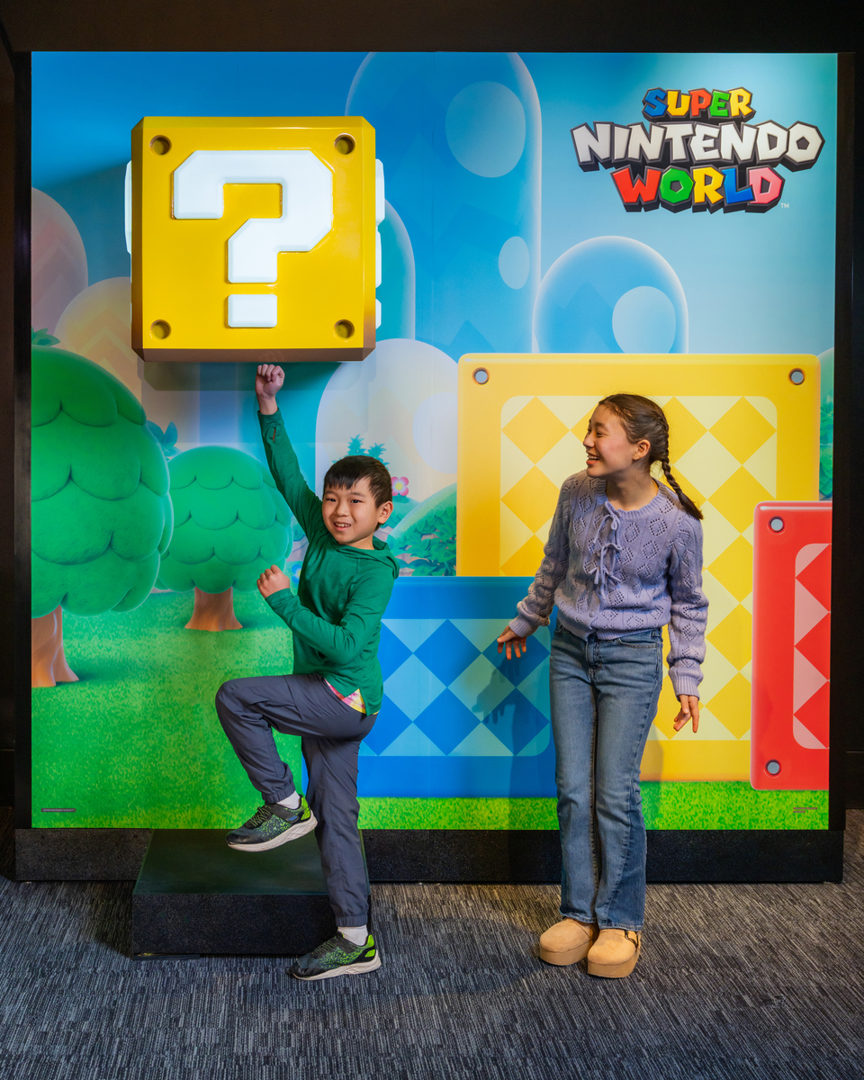 Two kids interact with a Super Mario exhibit at the Franklin Institute.