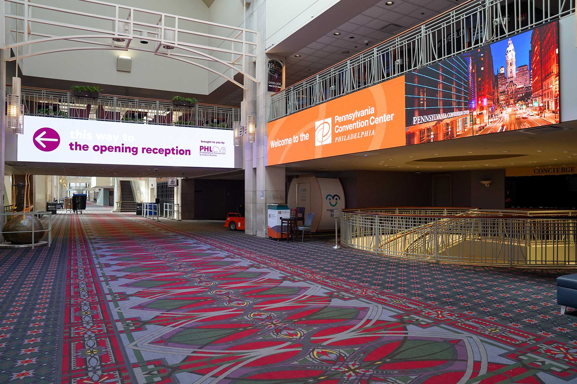 View inside of the PA Convention Center with large digital screens.