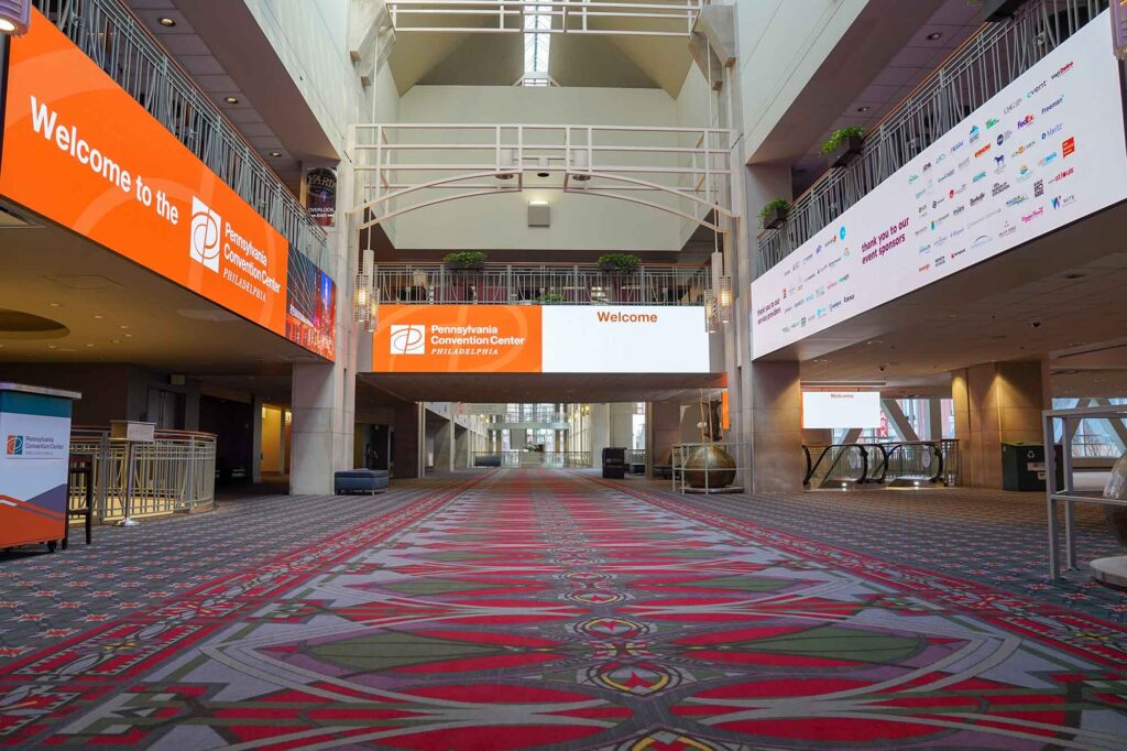 View inside of the PA Convention Center with large digital screens.