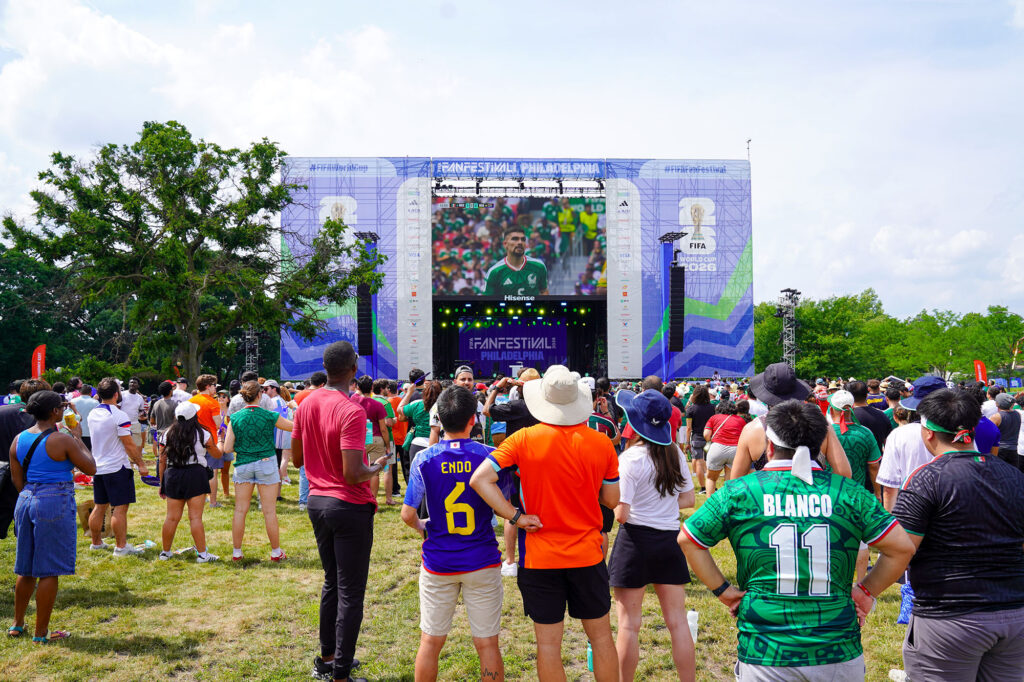 People gather around the FIFA Fan Festival screen to watch a World Cup match.