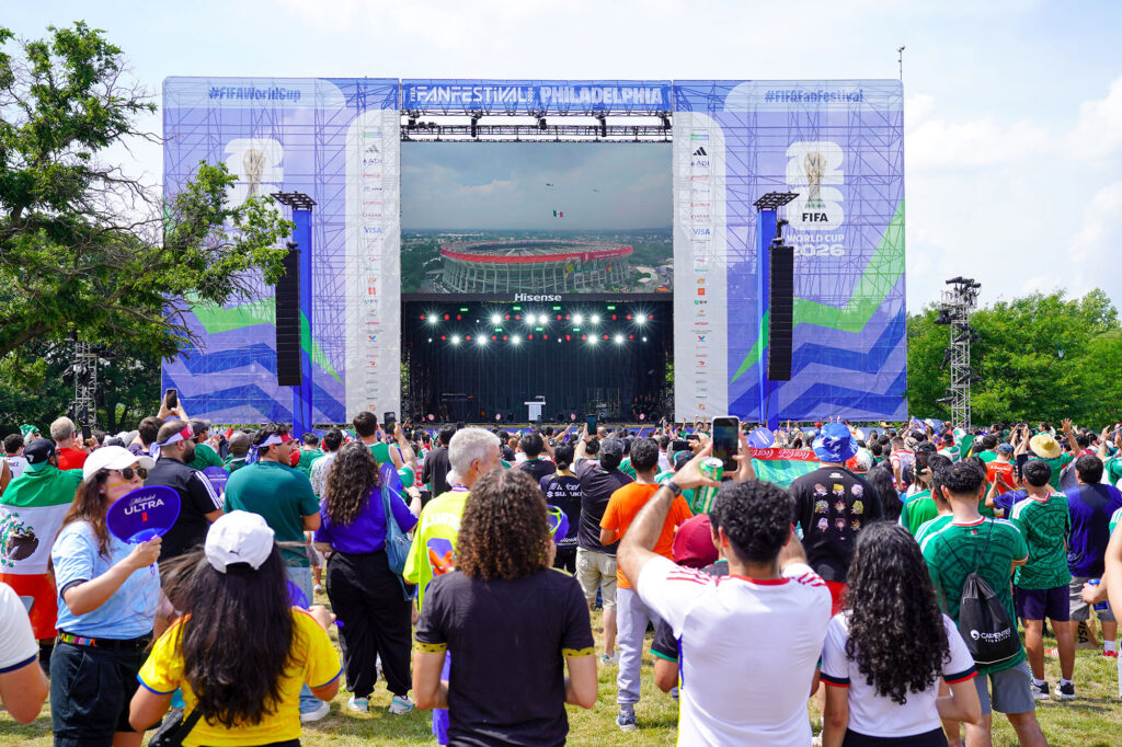 A crowd stands in front of a stage at the Philadelphia FIFA Fan Festival