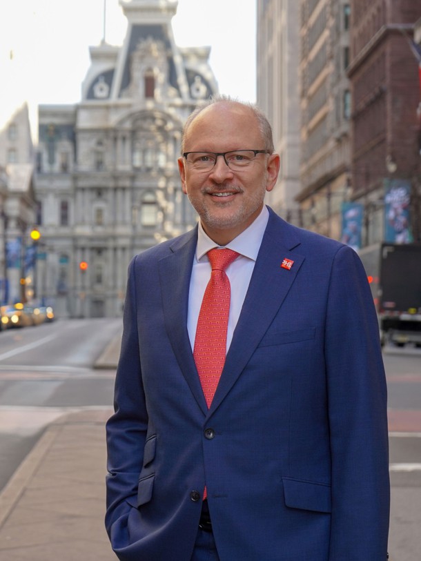 Gregg Caren headshot in front of Philadelphia City Hall