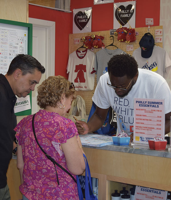 Two people ask for help at the Market Visitor Center.