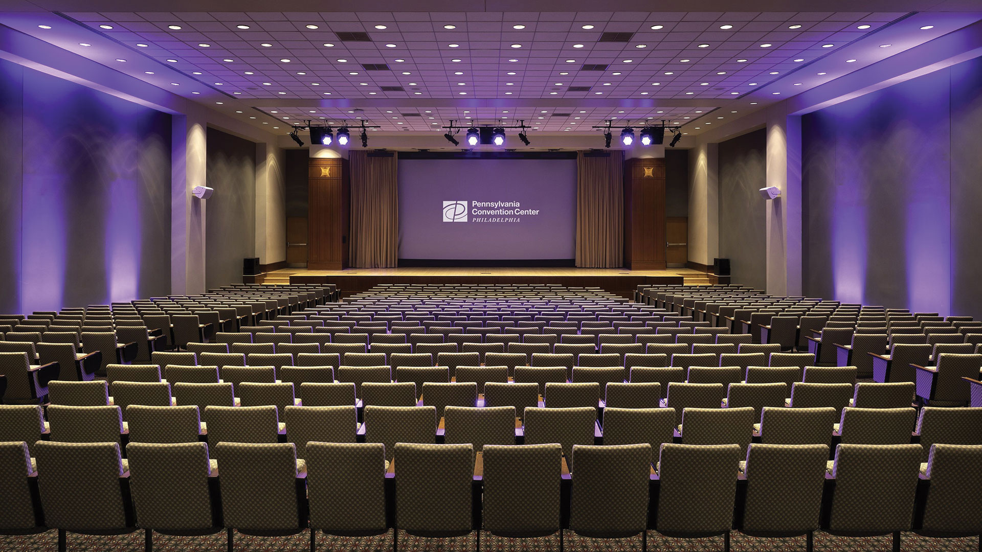 The interior of a theater in the PA Convention Center with a movie screen.