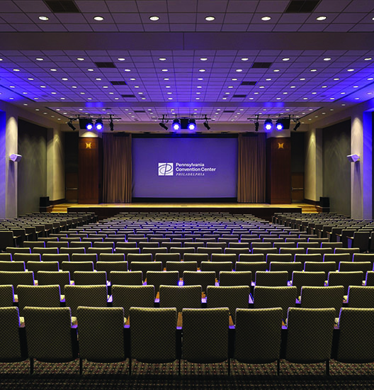 The interior of a theater in the PA Convention Center with a movie screen.