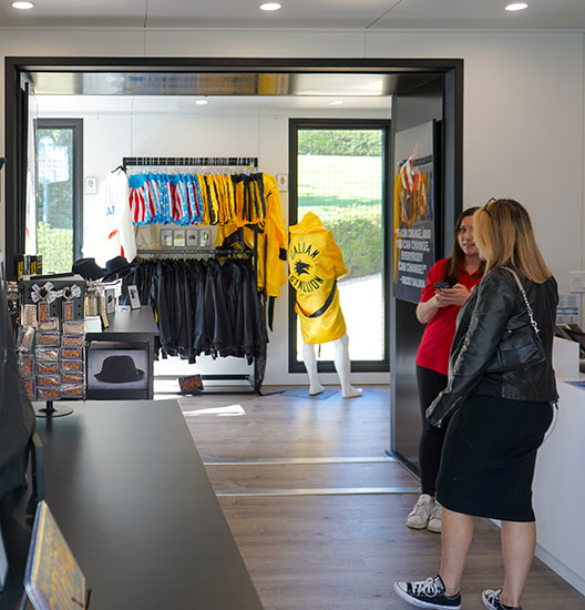 Two people stand in the Parkway Outpost Visitors Center.