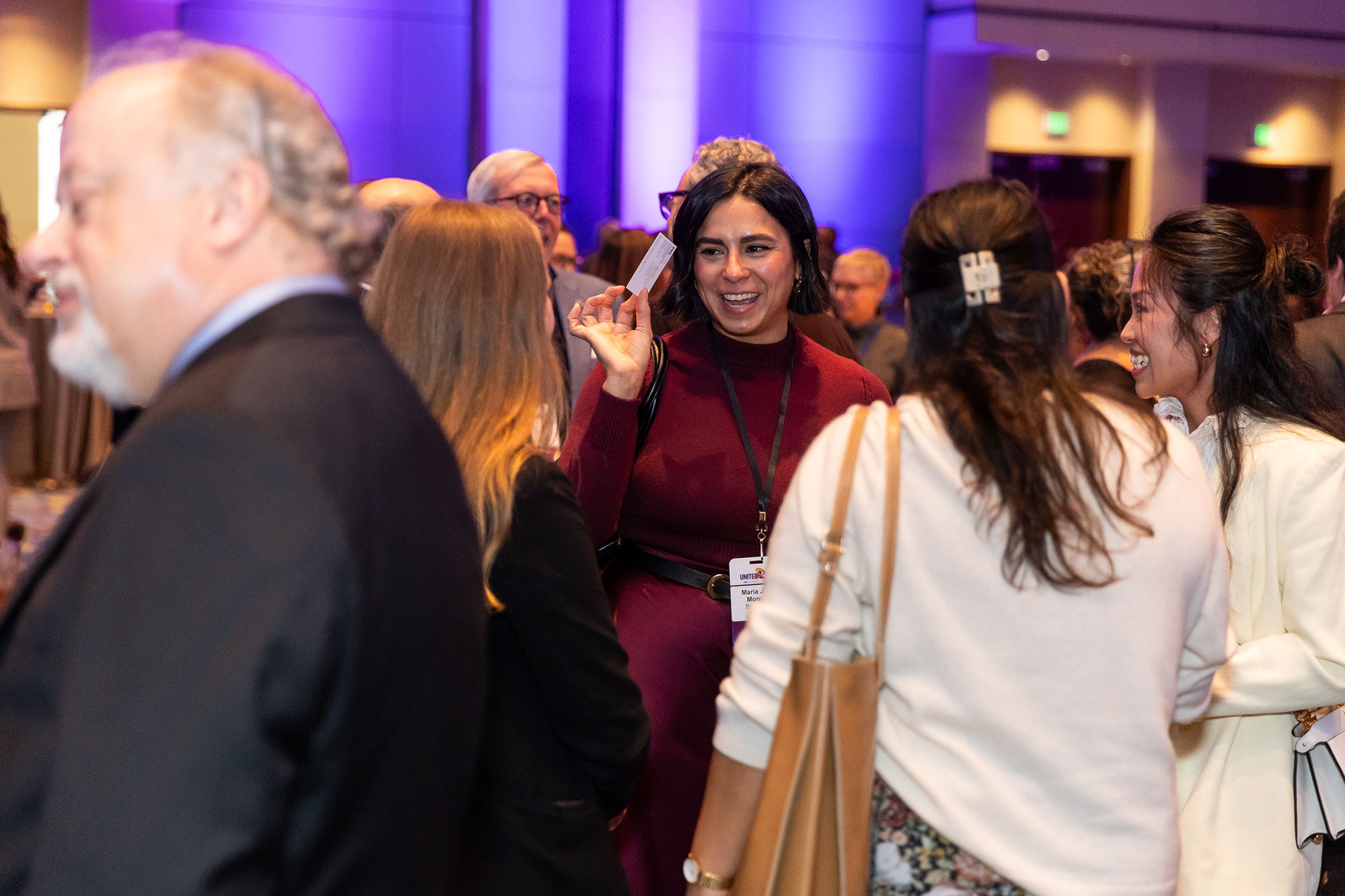 People chatting, enjoying themselves at the Annual Luncheon.